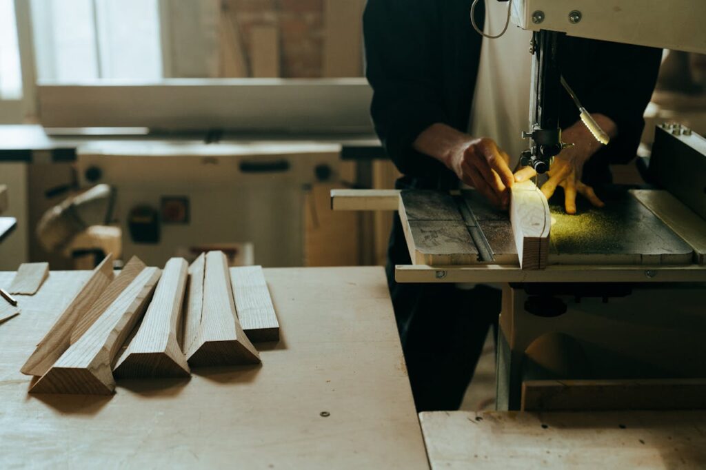 Person in Black Blazer Holding Brown Wooden Chopping Board